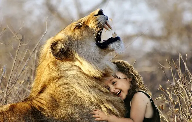 girl hugging lion